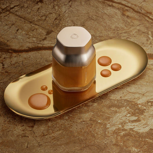 Manuka Honey Pinnacle Harvest MGO 1600+. Gold bottle and cap on a matching gold tray with a marble background.