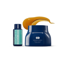 Blue jar of Manuka honey with a blue bottle labeled 'Immunity Elixir' on a green background