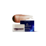 A jar of Manuka Health Eternal Renewal Nourishing Lip Balm with its navy blue box and a brown-to-beige product swatch behind it, set against a solid white background.