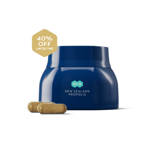Blue container labeled 'New Zealand Propolis' with two capsules on a green background